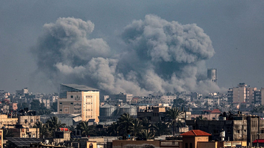 Gaza City skyline with rising smoke plumes during intensified Israeli strikes and ground push as hospitals report critical shortages.