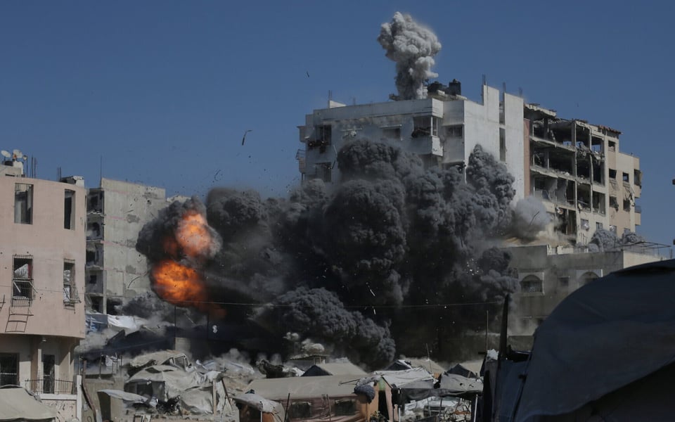 Smoke rises after an Israeli strike on an UNRWA school shelter in Gaza City amid fresh evacuation orders.