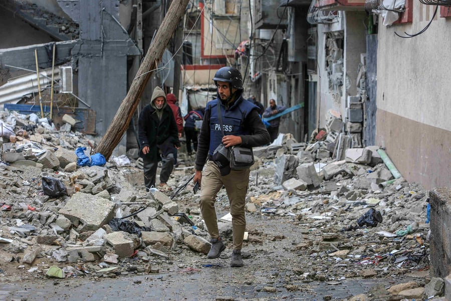 Journalists covering destruction in Gaza city during Israeli bombardment