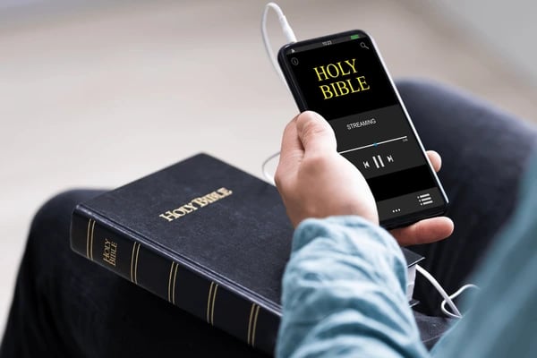 Young person reading scripture on a mobile phone app