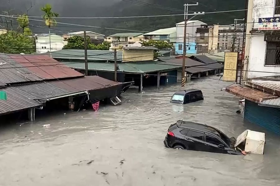 Satellite View Of Hualien Landslide-Dammed Lake Residents walk through mud in a flooded Hualien neighborhood after the barrier lake breach.