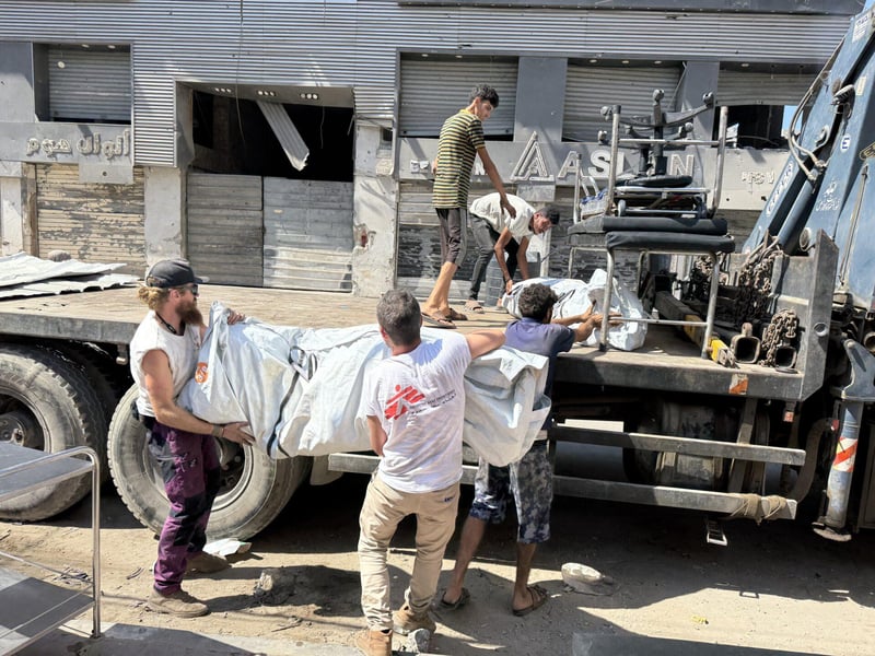 MSF staff and civilians near a clinic in Gaza City amid suspended services