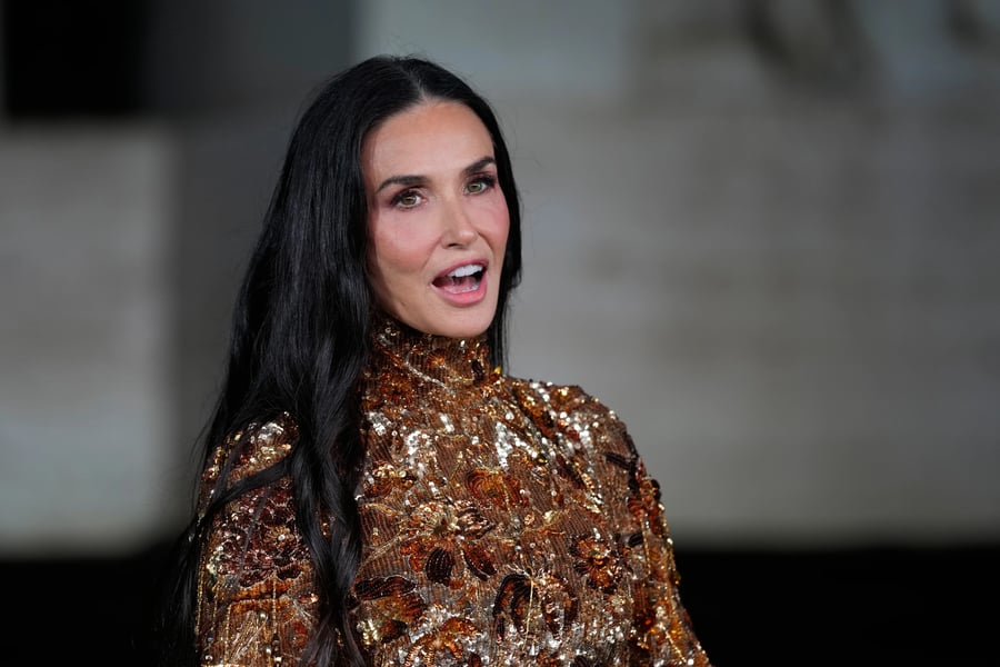 Demi Moore in a gold Gucci gown at “The Tiger” film premiere at Palazzo Mezzanotte during Milan Fashion Week