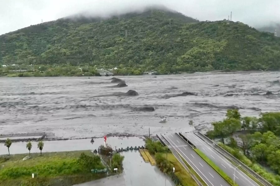 Rescuers survey a destroyed highway bridge in Guangfu, Hualien, after a barrier lake failed during Typhoon Ragasa.