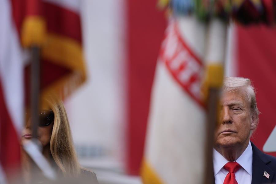 Donald Trump speaks as NATO flags fly in Brussels with an oil tanker backdrop symbolizing Russian crude