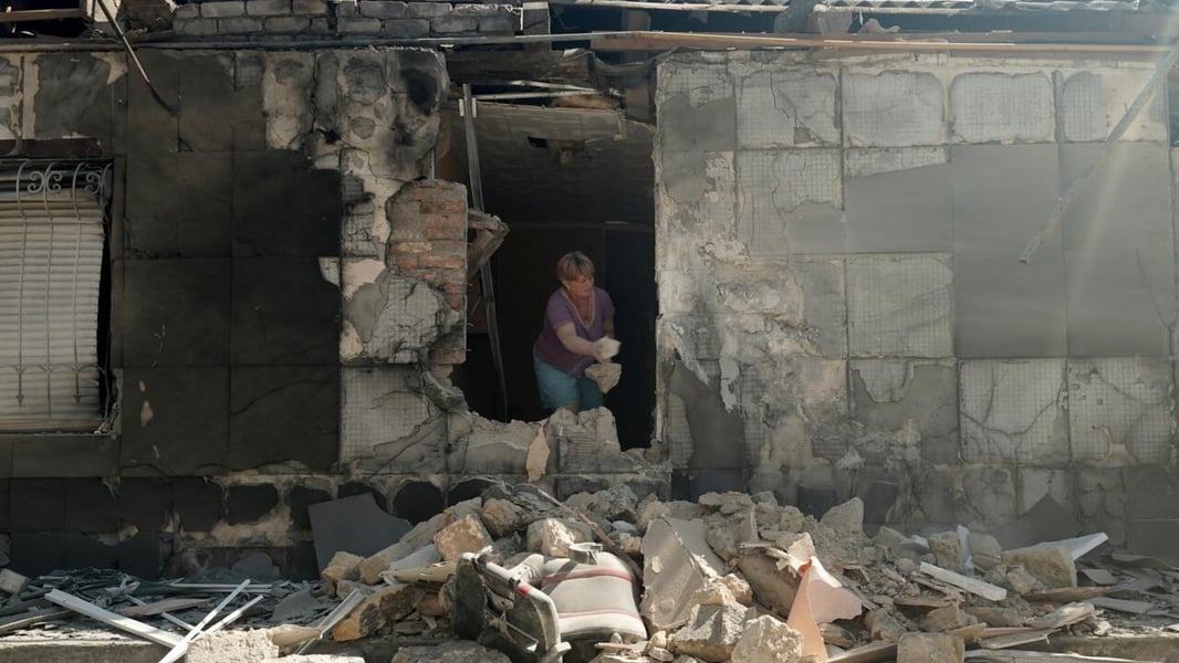 Rescue workers in Kherson clear debris after a Russian strike that hit residential blocks on Russia-Ukraine war day 1,311.