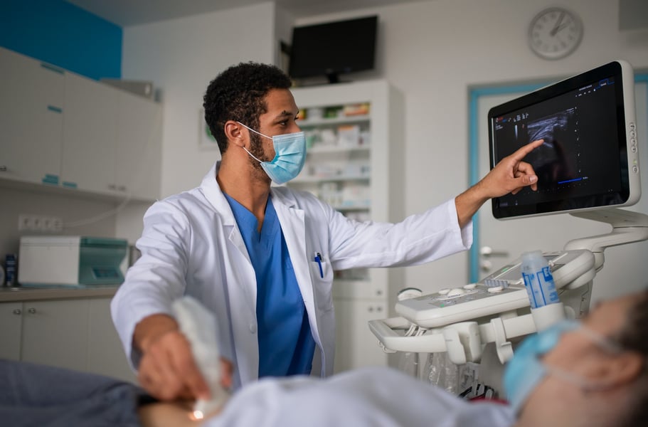 Hospitals Weigh Staffing Under New H-1B Costs US hospital clinicians in a corridor as H-1B fee raises staffing risks