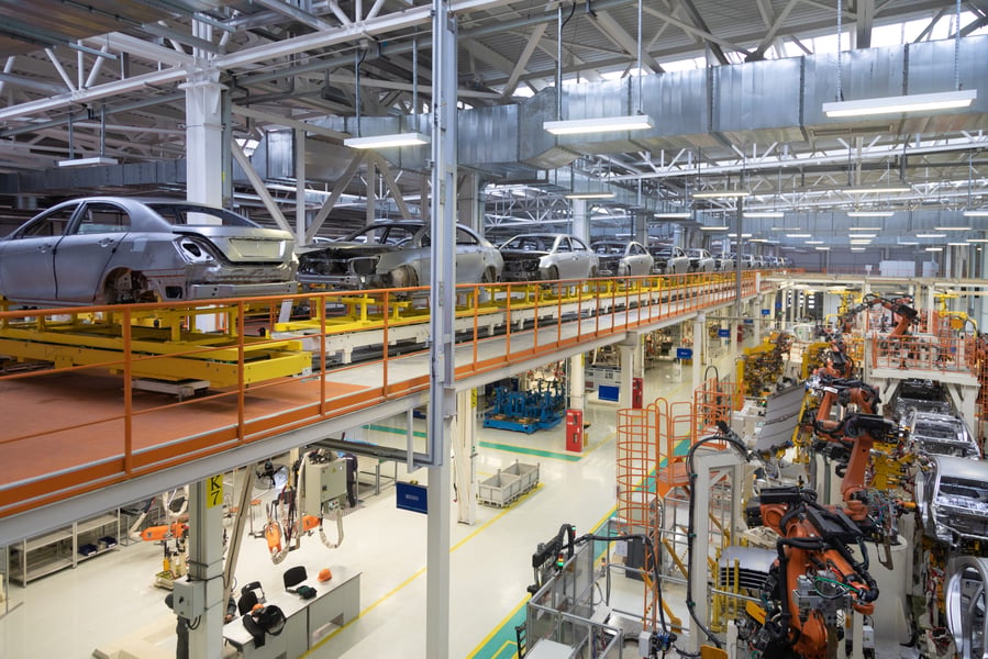 Auto assembly line in northern Mexico with vehicle bodies on conveyor as USMCA trade rules remain in force