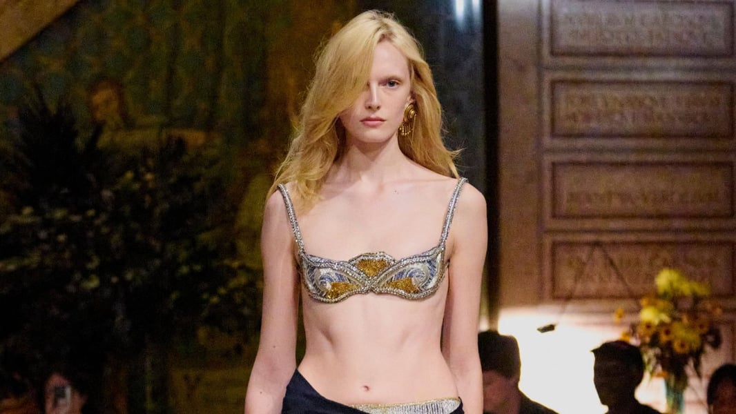 Models exit an intimate Versace presentation in Milan as Dario Vitale debuts his first collection.