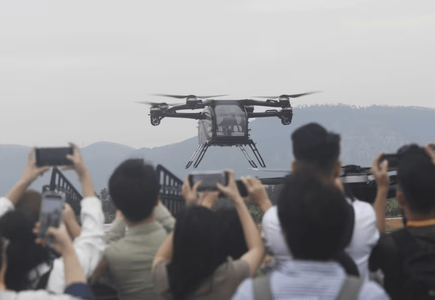 audience watches Xpeng AeroHT eVTOL modular flying car demonstration at China International Aviation & Aerospace Exhibition in Zhuhai