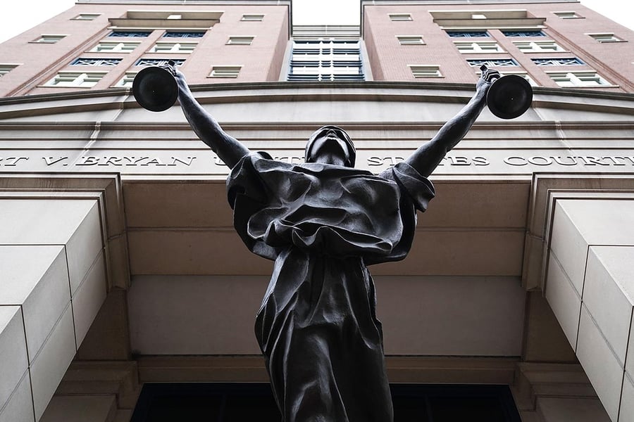 Albert V. Bryan United States Courthouse facade with Justice Delayed statue in Alexandria, Virginia