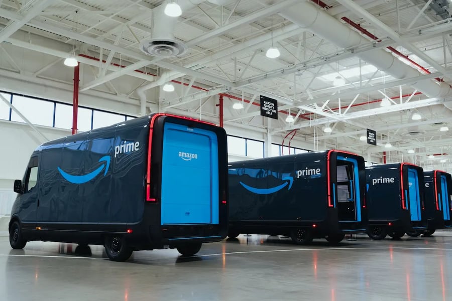 Amazon Rivian delivery vans lined up at a U.S. delivery station during the early holiday sales period
