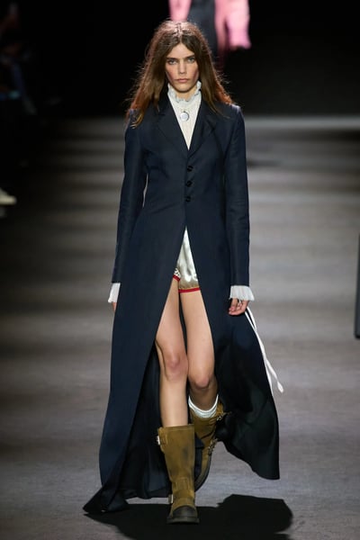 Ann Demeulemeester Spring 2026 runway model in black tailored jacket with tulle detail