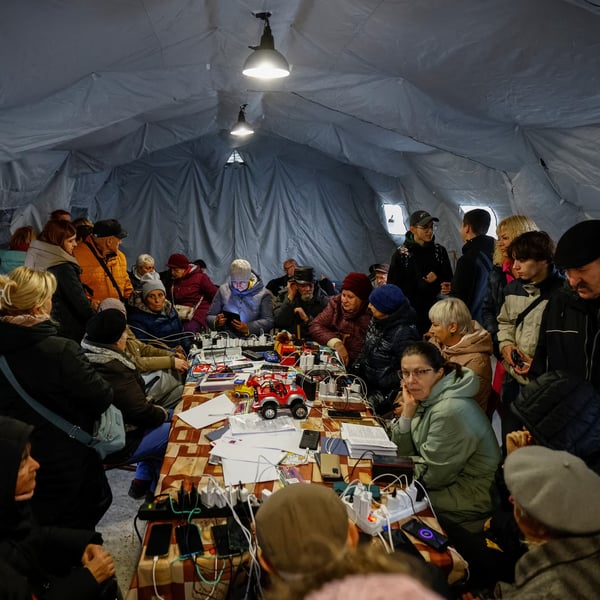 Charging and Heat During Blackouts, Chernihiv People charge phones and warm up at a public ‘Point of Invincibility’ in Chernihiv during power cuts.