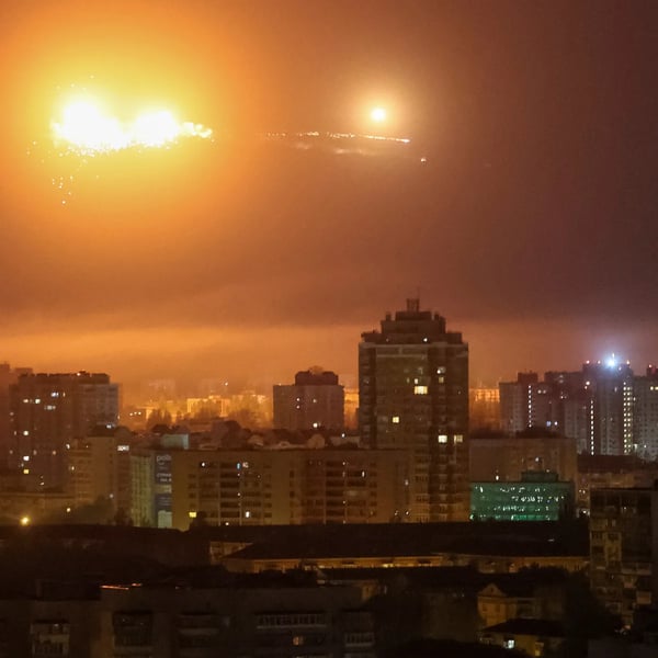 Night sky glows orange over Kyiv as an apartment block burns after a drone strike, Day