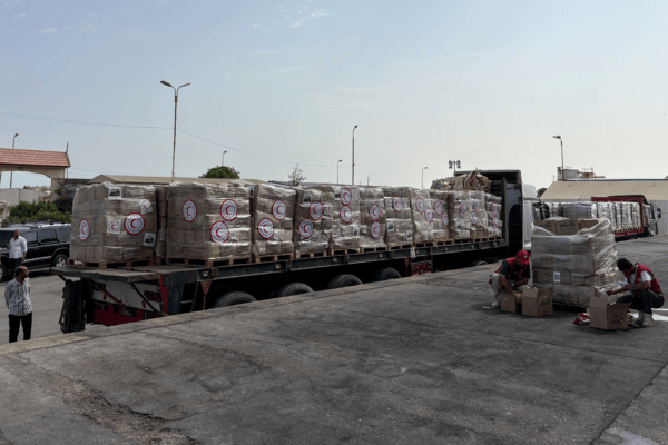 Aid trucks queued at Rafah crossing during a ceasefire window as approvals lag