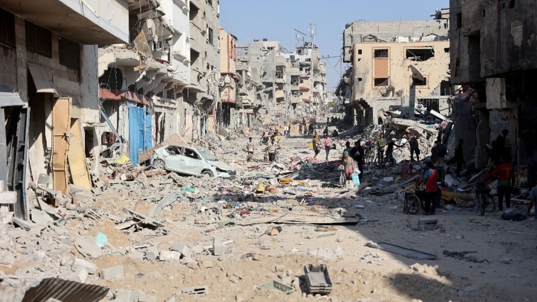 Residents pick through a shattered apartment to salvage belongings after returning during the ceasefire