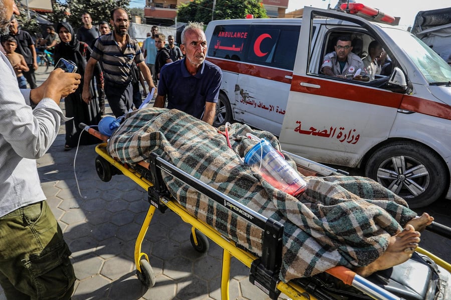Hospital staff check an oxygen manifold beside a diesel generator in Gaza
