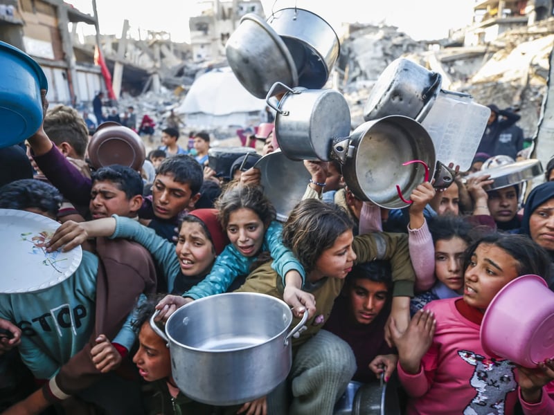 Children in Gaza queue for food at Jabalia as Israeli siege starves the enclave