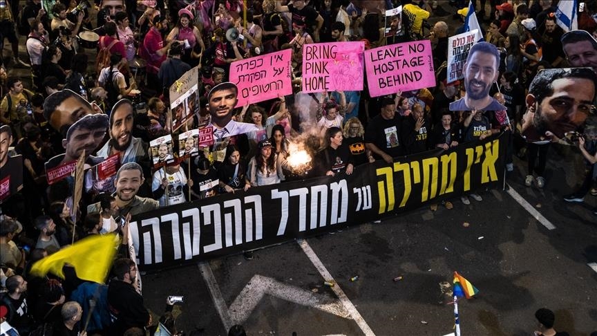 Families and supporters hold a nighttime vigil at Hostages Square in Tel Aviv