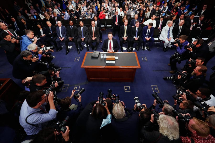 James Comey raises his right hand during a Senate hearing