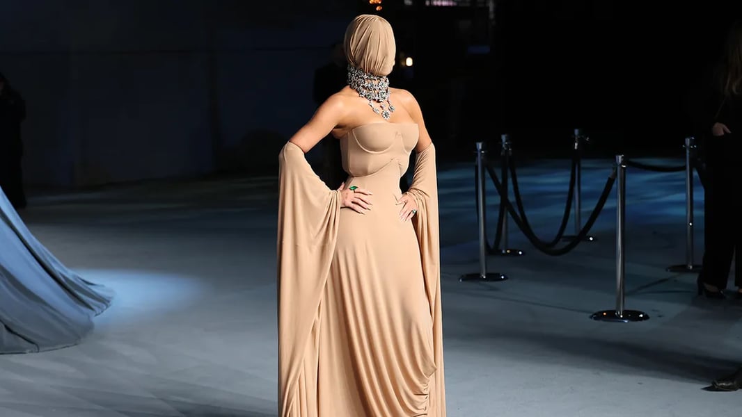 Kim Kardashian wearing a full-body Maison Margiela gown with a face mask at the 2025 Academy Museum Gala