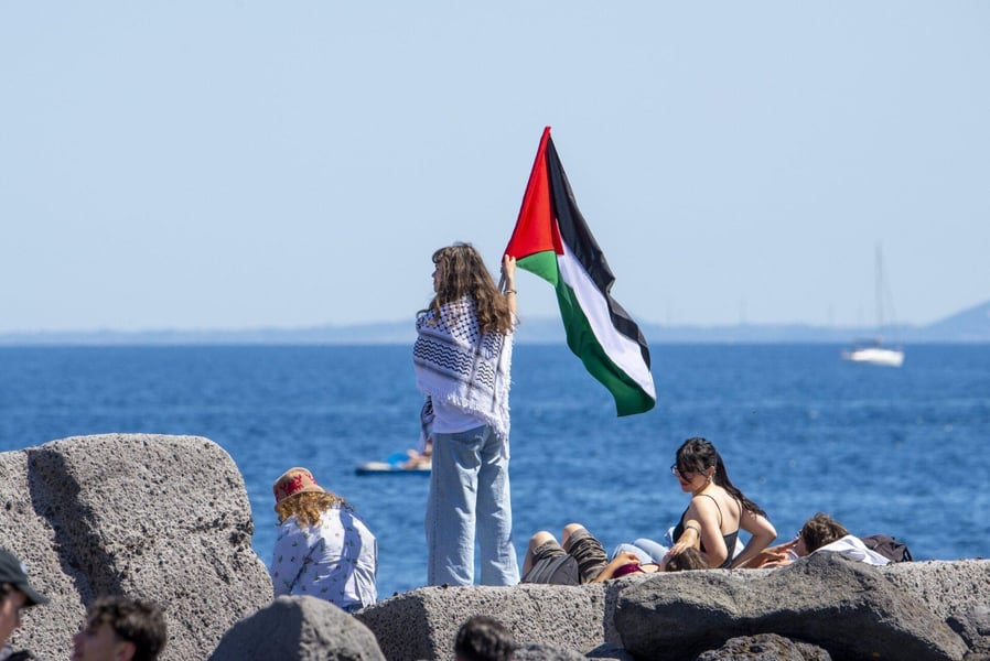 The yacht Madleen with a Palestinian flag on the bow during preparations in Sicily