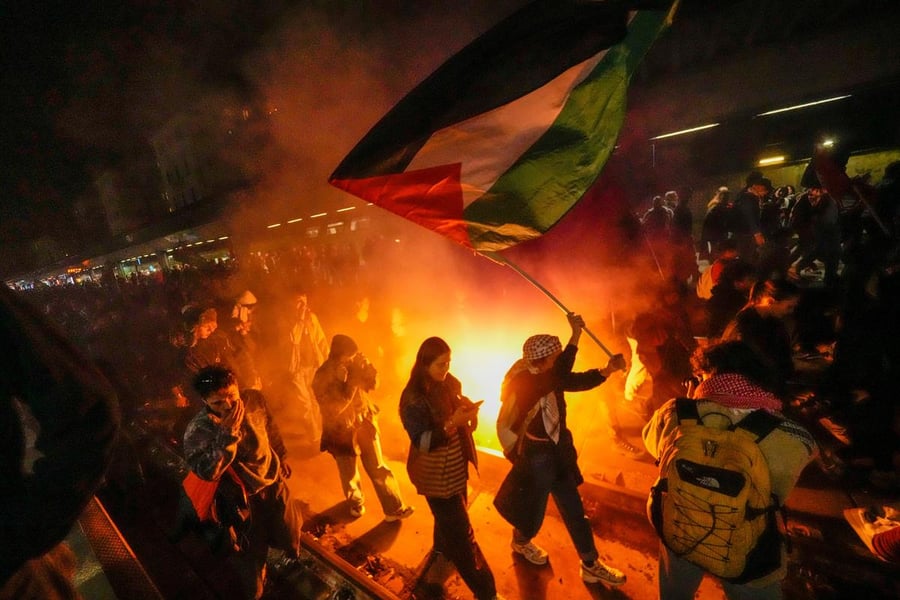 Israeli naval team boards the Marinette at night as activists hold up their hands