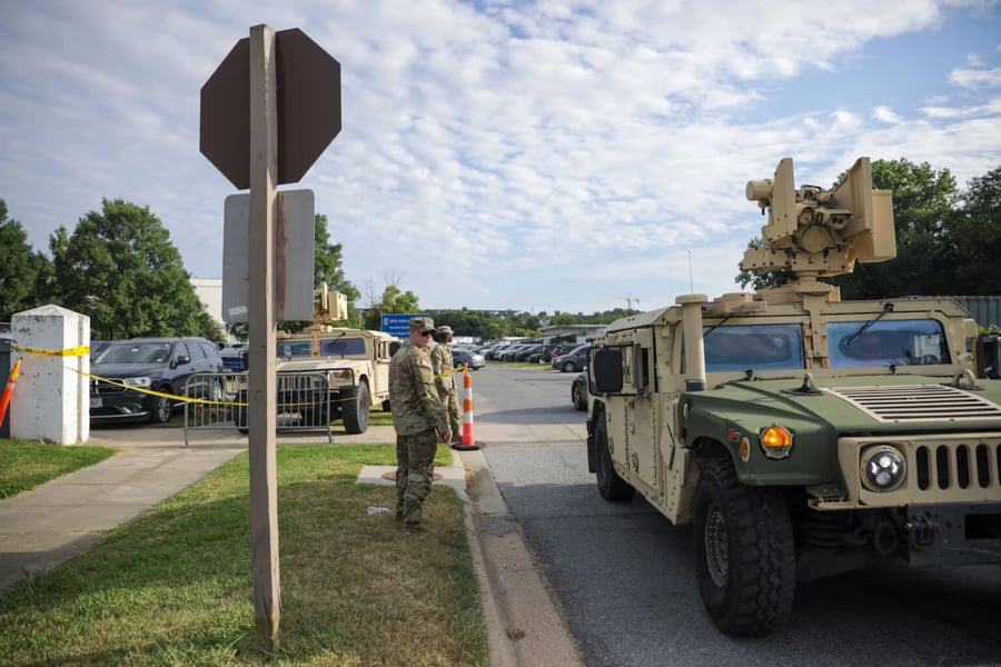 Army National Guard Humvee positioned for security support in a city corridor