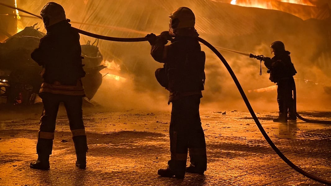 Firefighters extinguish a large blaze at an energy facility in Odesa region after a drone strike
