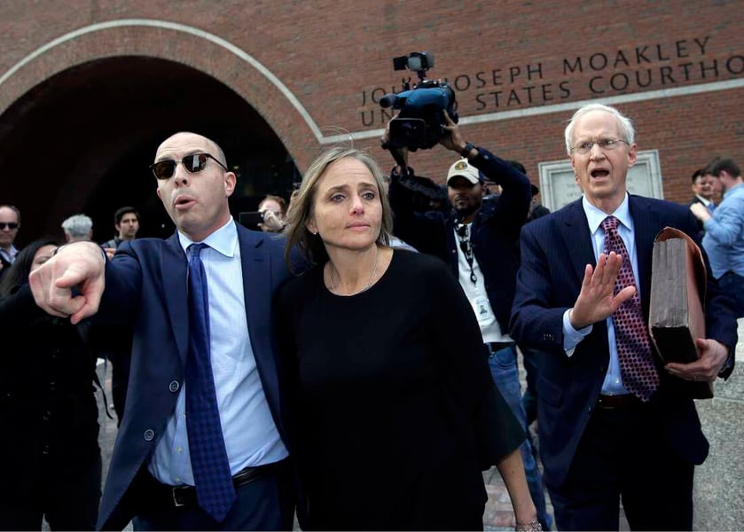 Lawyers and family members outside a courthouse after a detention hearing
