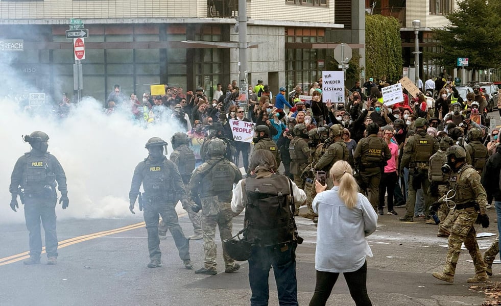Federal officers deploy tear gas outside the Portland ICE facility during a protest