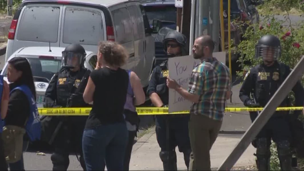 Police vehicles near Portland ICE facility after marchers arrive
