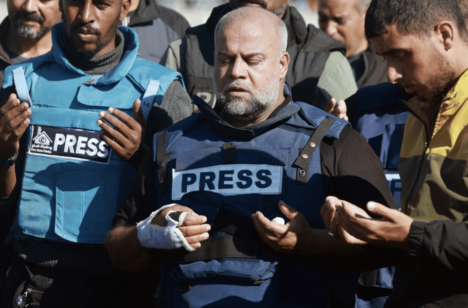 Journalists hold a vigil with press vests and candles