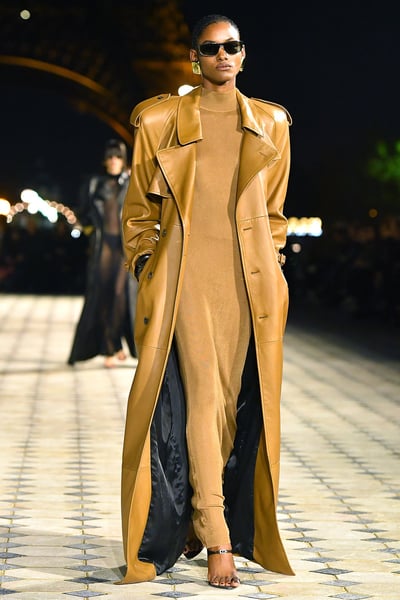 Model in mustard coatdress with high belt and black slingbacks at Saint Laurent Spring 2026