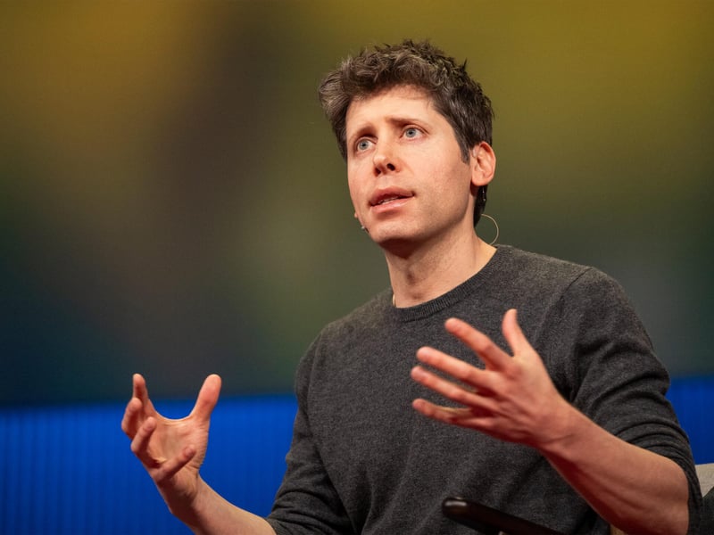Sam Altman speaking on stage about AI systems