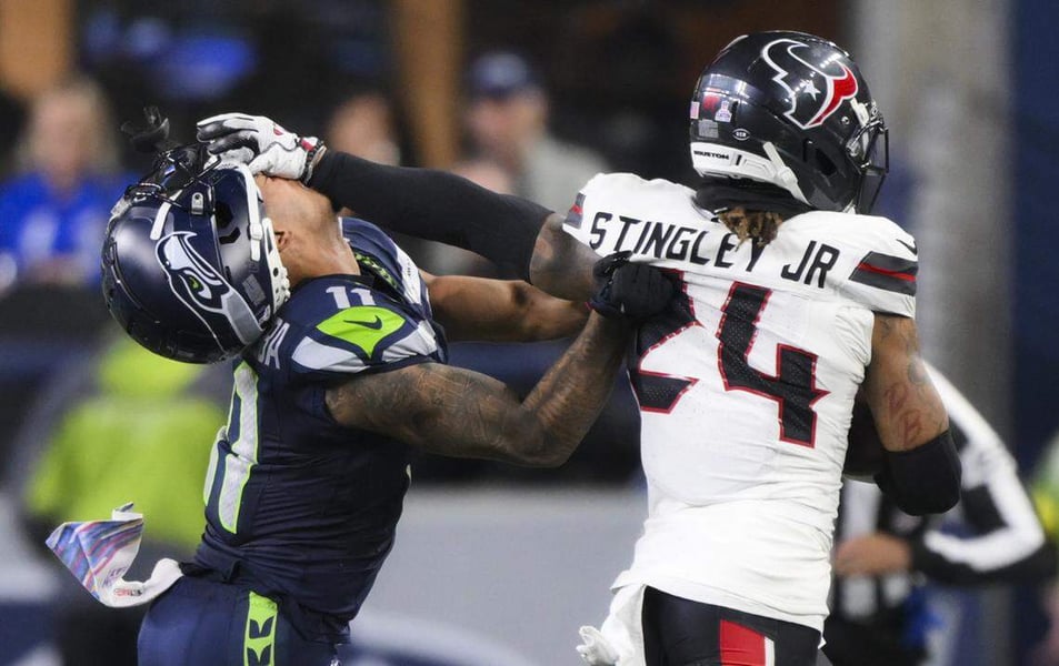 Jaxon Smith-Njigba loses his helmet while trying to stop Derek Stingley Jr. on a fourth-quarter interception return during the Seahawks vs Texans game at Lumen Field in Seattle.