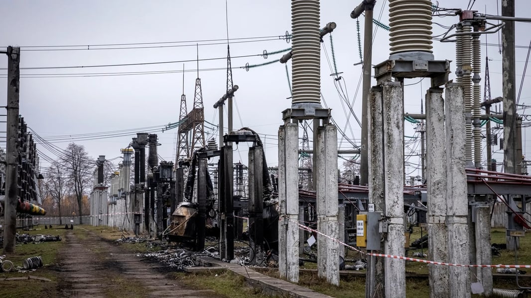 Ukrenergo technicians assess a burned transformer at a Kyiv substation after strikes
