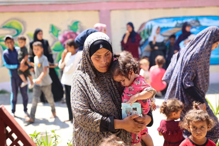 A mother and child wait during a nutrition screening at a UNICEF-supported clinic in the Gaza Strip.