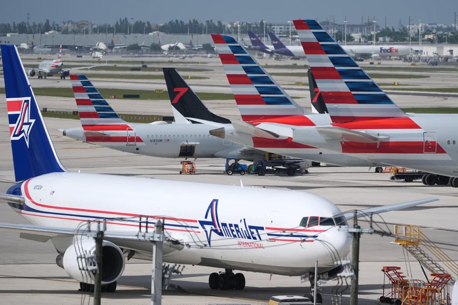 Air traffic control tower at major US airport during government shutdown with planes on tarmac