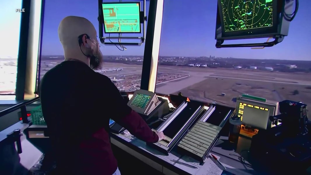 Air traffic controllers monitoring radar screens and flight data in control tower during government shutdown