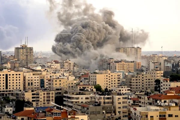Gaza skyline showing severe damage and smoke from ongoing conflict in 2025