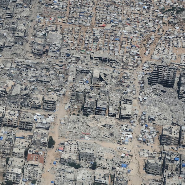 Aerial view of Gaza showing destruction and civilians awaiting aid during Israel-Palestine conflict day 721