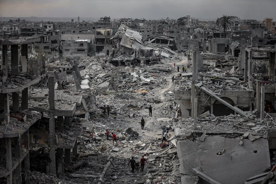 Gaza Day 716 devastation with destroyed buildings and civilians amid rubble