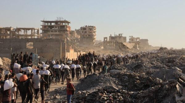 Humanitarian aid workers deliver supplies in Gaza amid post-conflict devastation