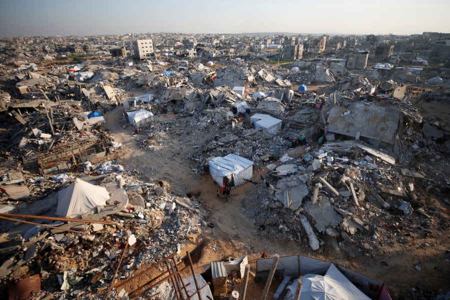 Gaza Humanitarian Crisis Continues Despite Ceasefire Displaced Palestinians amid destroyed buildings in Gaza during fragile ceasefire November 2025