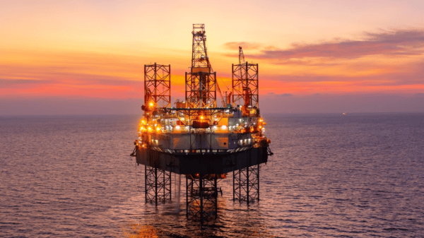 Oil refinery industrial plant at sunset representing IEA fossil fuel demand forecast until 2050