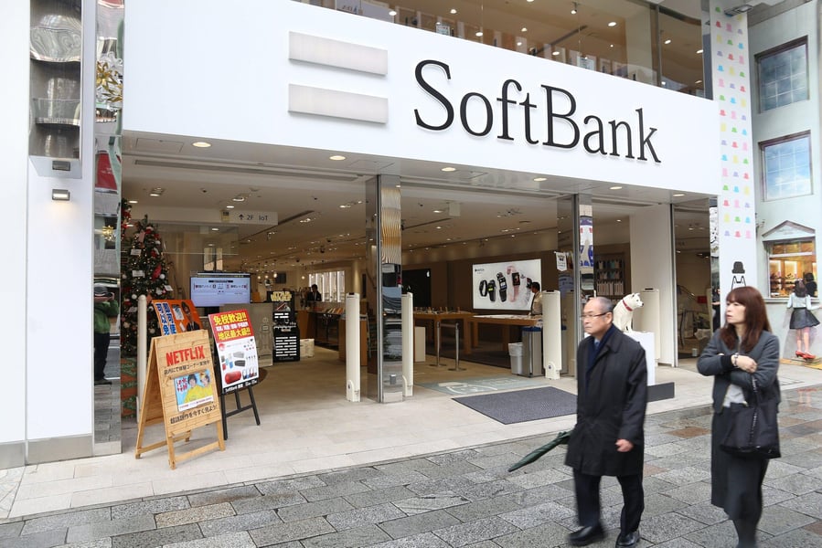 SoftBank Faces Major Losses From Nvidia Selloff SoftBank building with downward trending stock arrows