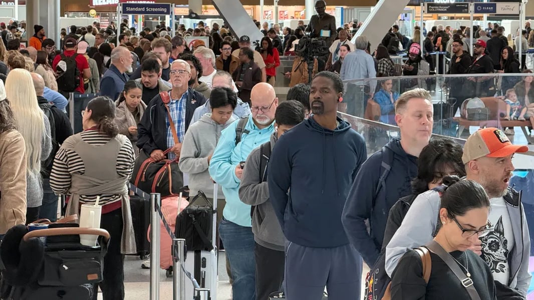 Stranded airline passengers dealing with flight cancellations at US airport during government shutdown