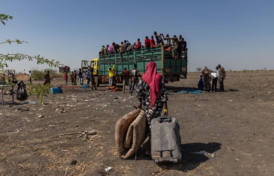 Sudan Refugees Flee to Chad Amid Civil War Violence Sudanese refugees carrying belongings while crossing into Chad during the civil war displacement crisis